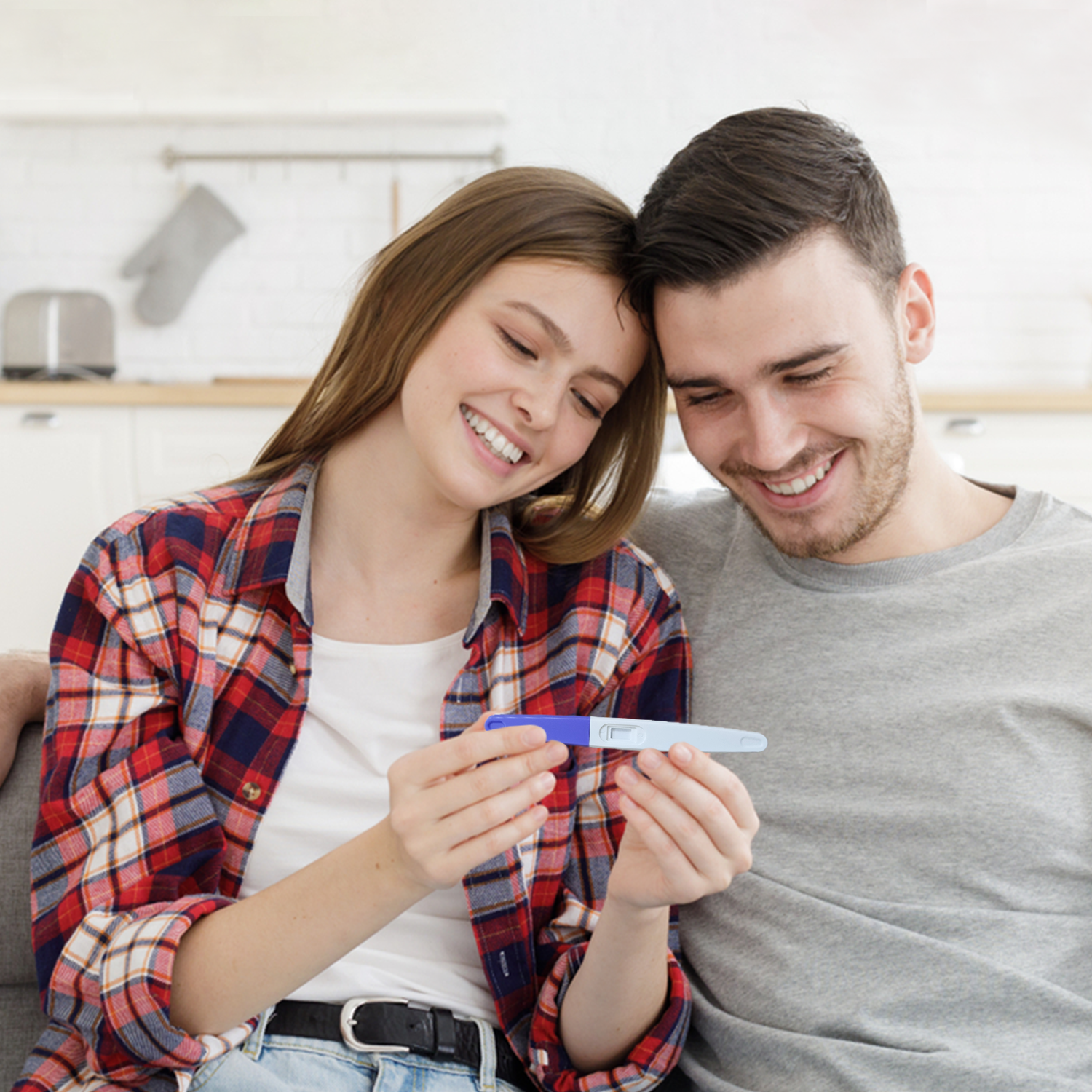 couple using ovulation test health monitoring device at home